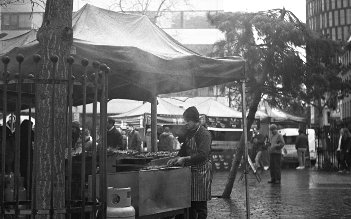 Film Photography London: 10 Spots for Street Shots, Vinyl & Hidden Gems | Alfie B-Smith Street food steam meeting the rain. The texture you get from black-and-white film in these conditions is unmatched.